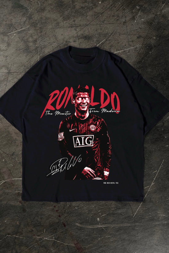 Black t-shirt with a graphic of a Cristiano Ronaldo in a sports jersey and 'Ronaldo' text on a dark textured background