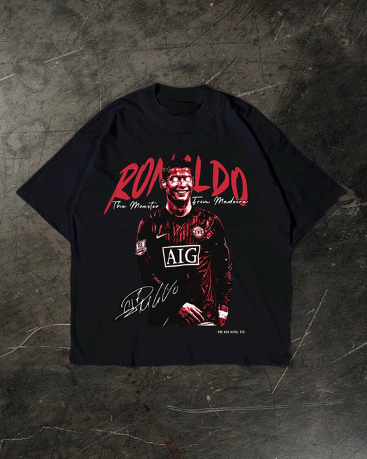 Black t-shirt with a graphic of a Cristiano Ronaldo in a sports jersey and 'Ronaldo' text on a dark textured background